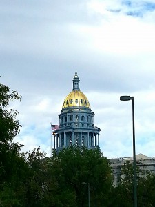 Capitol dome with U.S. and Colorado flags.