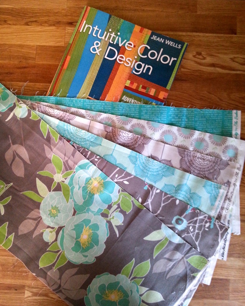 The inspiration pieces and the book I am using to guide me.  I like the color palette and am free to add more solids and patterns as long as they come from the same fabric line.