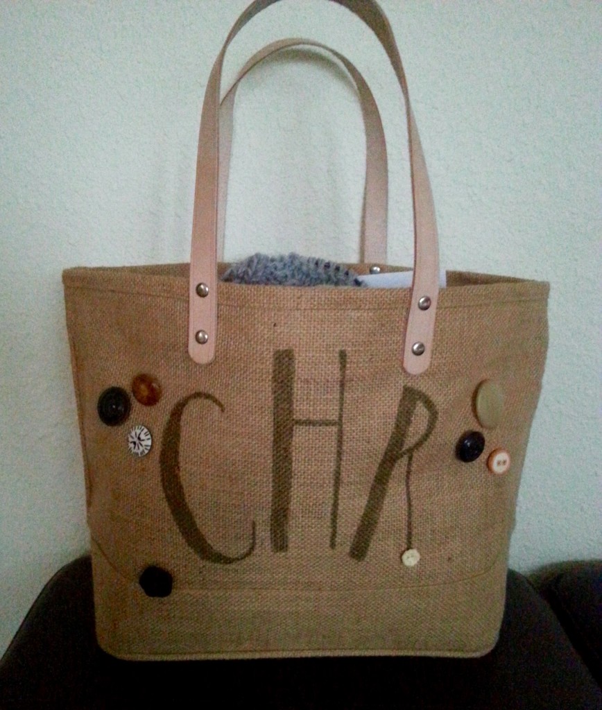 Spur of the moment creation.  We received the burlap tote as a welcome gift at a wedding we attended recently.  The blank canvas of it kept nagging at me so I decided to experiment.  One Sharpie and eight buttons later I had this.